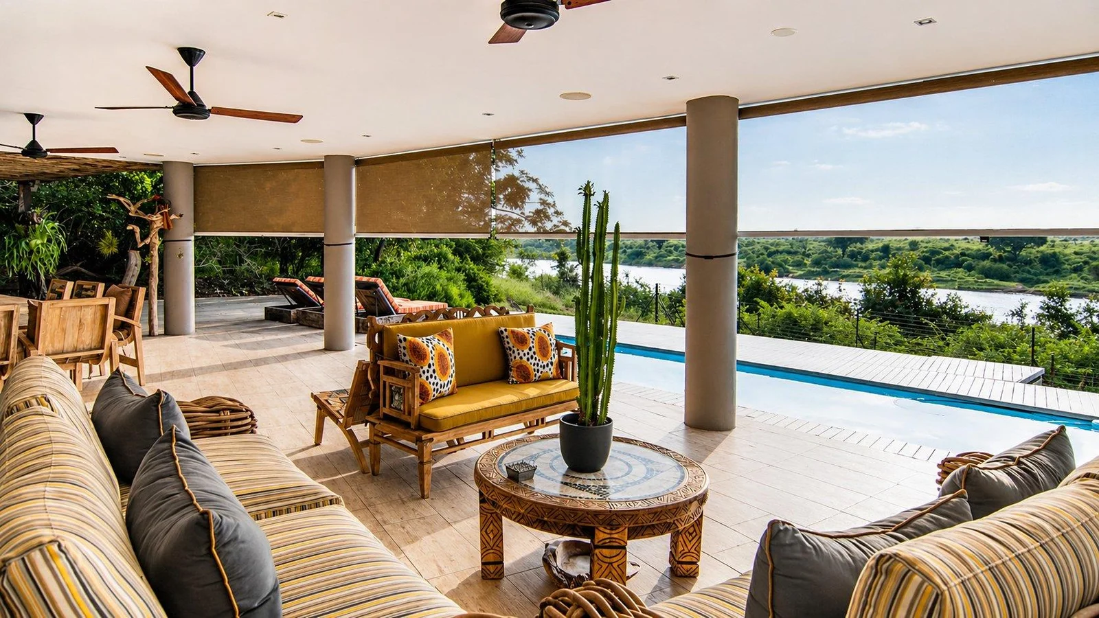 Covered lounge with cane sofas facing the pool and the river
