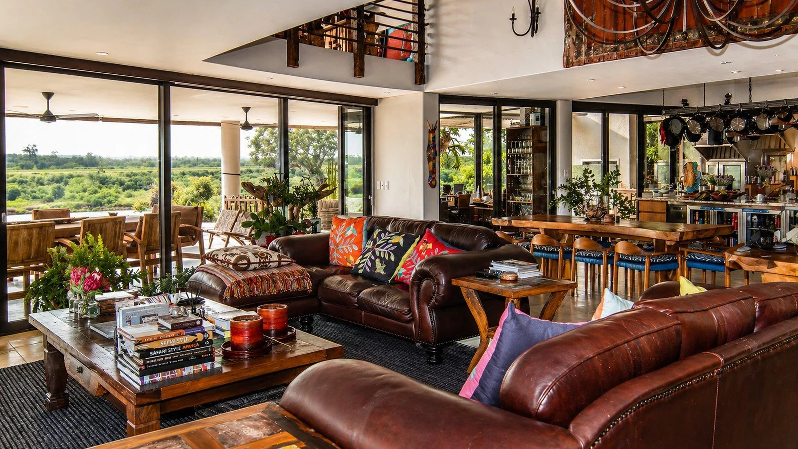 Living area with leather sofas, reclaimed-timber walls and a television above a fireplace