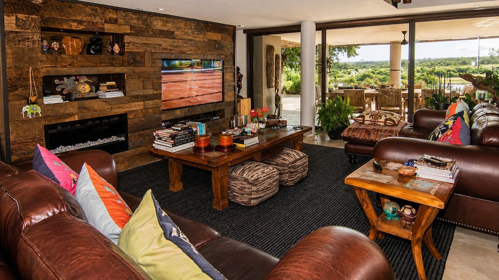 Sitting room with a glass-sided fireplace and reclaimed-timber wall