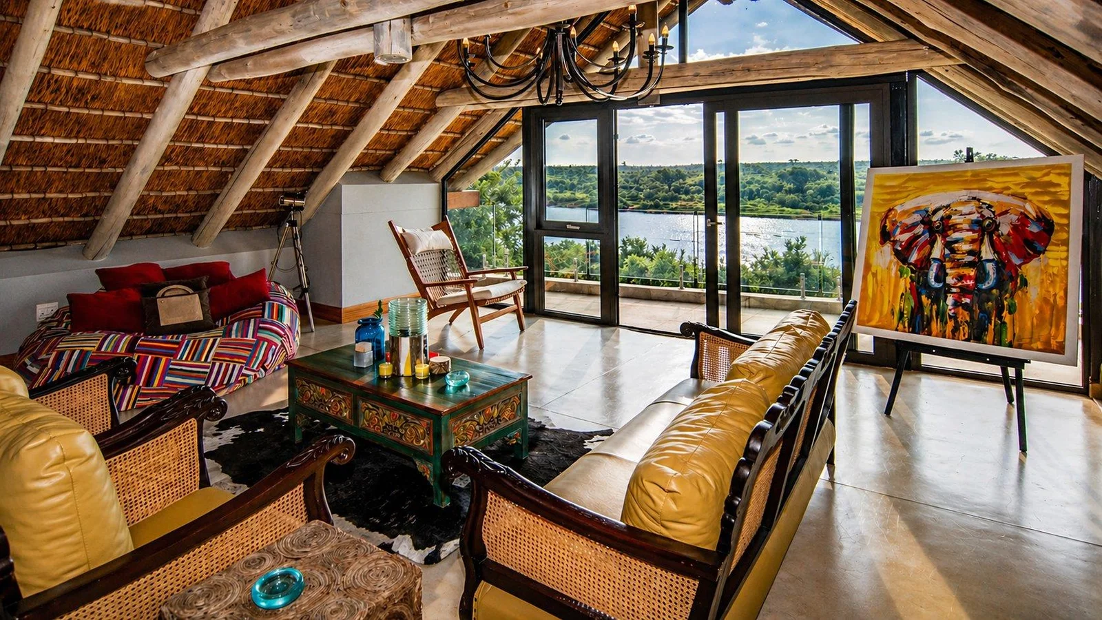 Loft sitting area with yellow leather sofas and the river through the glazing