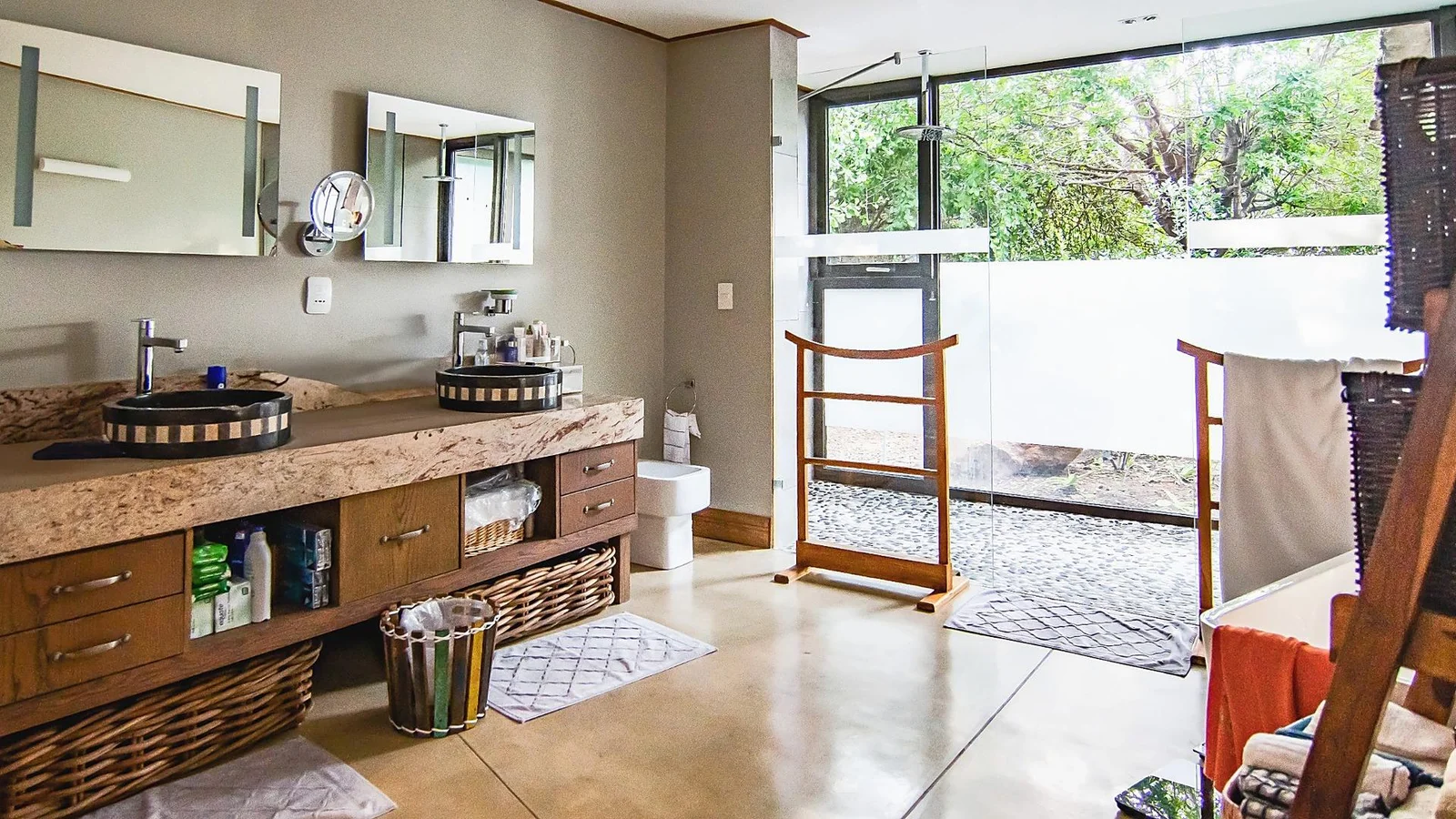 En-suite bathroom with a timber vanity and glass doors to the garden